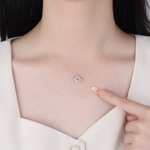 Diamond necklace being pointed to on a person wearing a white shirt