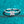 Silver ring with a square-cut diamond on a teal glittery background