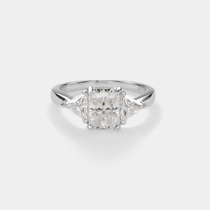 Diamond ring with a central square-cut diamond and two smaller diamonds on a light gray background
