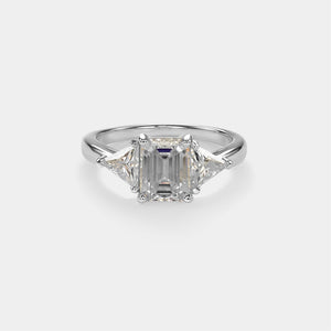 Diamond ring with a rectangular stone on a light gray background