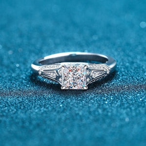 Silver ring with a diamond on a blue textured background