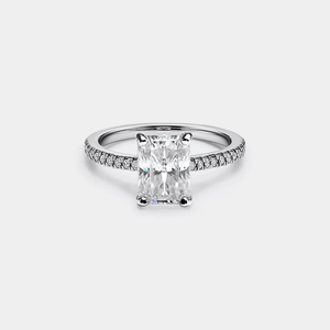 An engagement ring featuring an emerald-cut moissanite centerpiece with hypoallergenic platinum plating and small diamond accents around the band.
