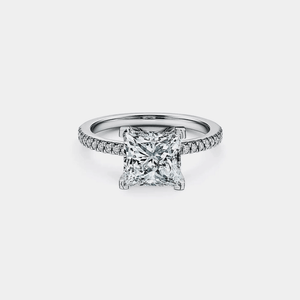 Diamond ring with a square-cut gemstone on a light gray background
