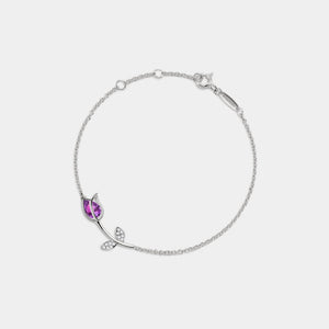 Silver bracelet with a purple gemstone on a white background