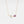 Delicate gold necklace with a purple gemstone pendant on a white background
