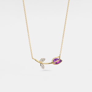 Delicate gold necklace with a purple gemstone pendant on a white background