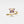 Gold butterfly ring with purple gemstones on a white background