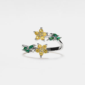 A gold-plated sterling silver bypass ring with purple and green cubic zirconia stones designed to resemble flowers, with an adjustable band.