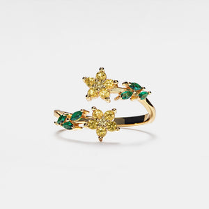 A gold-plated sterling silver bypass ring with purple and green cubic zirconia stones designed to resemble flowers, with an adjustable band.