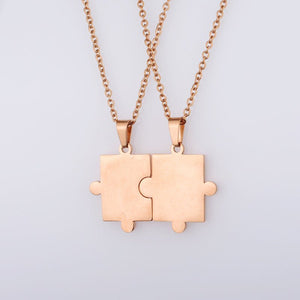 A collection of puzzle piece matching couple pendant necklaces in various colors including silver, gold, and rose gold.