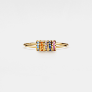 Gold bracelet with colorful gemstones on a white background