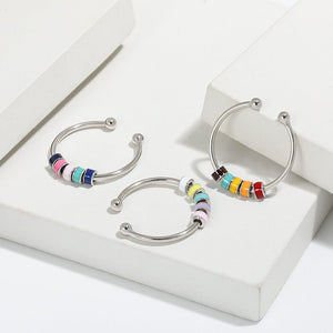 Silver hoop earrings with colorful beads on a white background