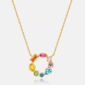 Gold necklace with colorful gemstones on a white background