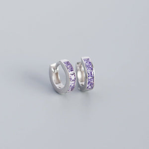 A pair of gold-plated huggie hoop earrings with multicolored gemstones