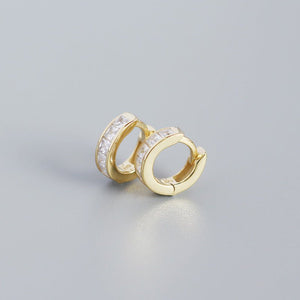 A pair of gold-plated huggie hoop earrings with multicolored gemstones