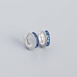 A pair of gold-plated huggie hoop earrings with multicolored gemstones