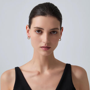 Woman wearing a black sleeveless top against a plain background