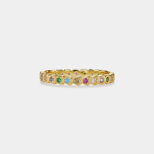 Gold ring with colorful gemstones on a white background