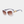 White sunglasses with gold accents on a light gray background