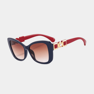 Sunglasses with red arms and blue lenses on a light gray background