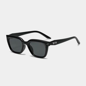 Black sunglasses with a gray lens on a light gray background