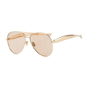 Gold aviator sunglasses with pink-tinted lenses on a white background