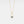 Gold necklace with a blue gemstone pendant on a light gray background