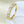 Gold ring with heart-shaped diamonds on a light background