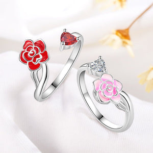 Two silver rings with red and pink flower designs on a white background