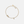 Gold bracelet with decorative elements on a light beige background