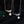 Two pearl necklaces, one gold and one silver, on a dark background.