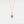 Gold necklace with a blue gemstone pendant on a light gray background
