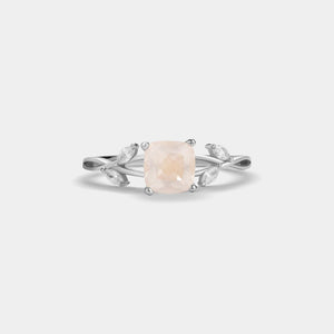 Silver ring with a pink gemstone on a white background
