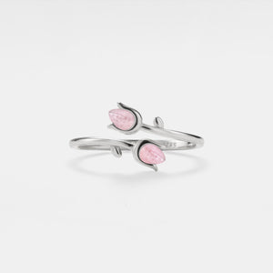 Silver bracelet with pink stones on a light gray background