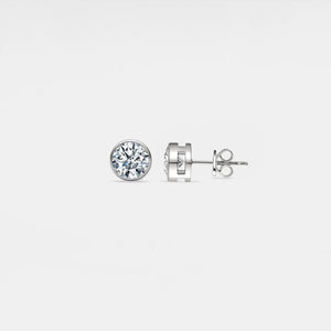 Diamond stud earrings on a light gray background