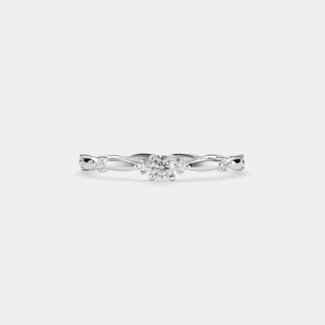Silver ring with a diamond on a light gray background