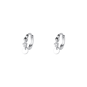 Silver hoop earrings with small round charms on a white background
