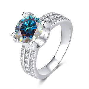 A collection of six moissanite cocktail rings with pave settings, displayed in a variety of colors including colorless, blue, yellow, red, and green.