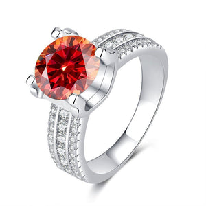 A collection of six moissanite cocktail rings with pave settings, displayed in a variety of colors including colorless, blue, yellow, red, and green.
