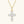 Gold cross-shaped pendant with clear stones on a white background
