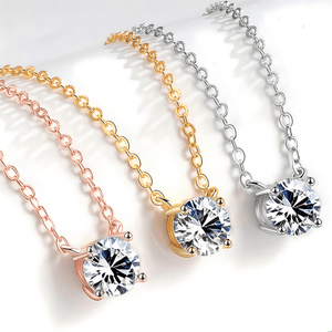 Three necklaces with round pendants in gold, rose gold, and silver on a white background.