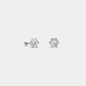 Pair of diamond stud earrings on a light gray background