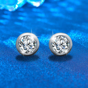 Pair of diamond stud earrings on a blue background