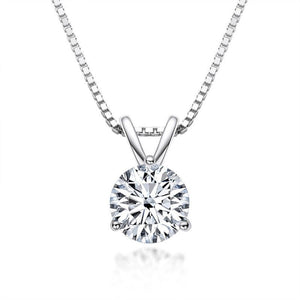 A round moissanite gemstone pendant set in a gold-colored mounting, displayed on a gold chain.