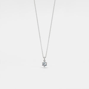 Silver necklace with a teardrop-shaped pendant on a light gray background