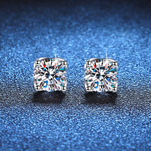 Pair of diamond stud earrings on a blue textured background