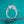 Silver ring with a large central gemstone on a teal background