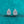 Teardrop-shaped diamond earrings on a teal glitter background