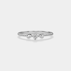 Silver ring with a diamond on a light gray background
