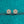 Gold flower-shaped earrings with clear stones on a teal glittery background